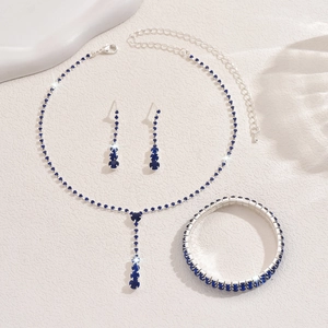 Detailed view of silver-tone bridal jewelry set featuring navy blue rhinestones and tassels