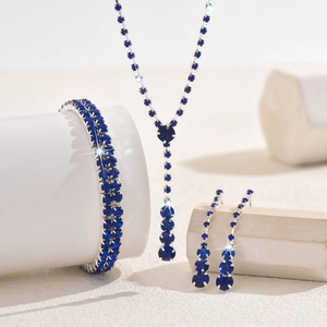 Macro shot of silver jewelry set with deep blue rhinestones on geometric stands