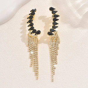 Detail view of long tassel earrings with black stones and sparkling diamond fringe
