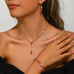 Close-up of elegant wedding jewelry set with red sparkling crystals and silver plating