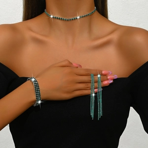Detail view of shimmering green rhinestone choker, elastic bracelet, and fringe earrings set