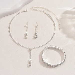 Close-up of sparkling double-row diamond jewelry set with necklace earrings and bracelet