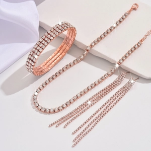 Detail view of a rose gold jewelry set featuring rhinestone bracelet, necklace, and earrings
