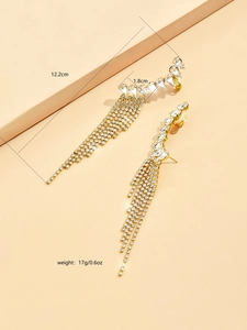 Detailed view of long gold tassel earrings with crystal rhinestones and 12.2cm length scale