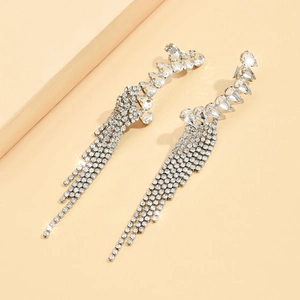 Detail of silver long tassel earrings with sparkling rhinestones and crystal studs