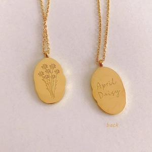 Golden stainless steel oval pendant necklace featuring April Daisy floral engraving