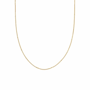 Detailed close-up of a minimalist gold necklace with refined vacuum-plated texture