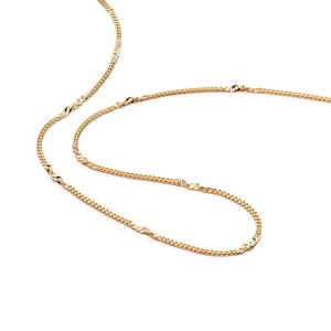 Detail of multi-layered gold curb chain necklace with elegant twisted texture design