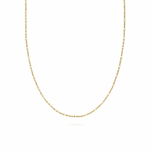 Detailed close-up of a delicate layered gold twisted chain with fine spiral texture