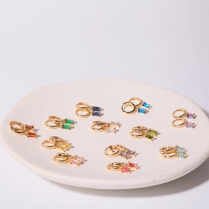 Set of twelve pairs of gold-tone earrings featuring various rectangular colored zircons