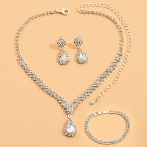 Close-up of sparkling bridal jewelry set with pear-shaped rhinestones on warm background