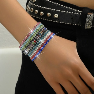 Close-up of stacked colorful rhinestone bracelets in pink, blue and green on wrist