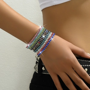 Close-up of stacked colorful zircon tennis bracelets with silver prong settings