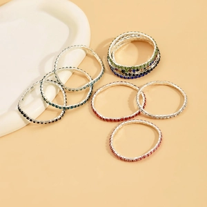 Detailed view of colorful rhinestone elastic bracelets with sparkling square-cut zircons