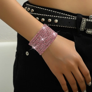 Close-up of a wide pink rhinestone stretch bracelet worn on wrist with sparkling crystals