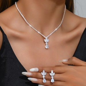 Close-up of model wearing silver zircon teardrop necklace and matching earrings set