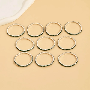 Set of 10 silver stretch rings featuring green circular rhinestones in a grid layout