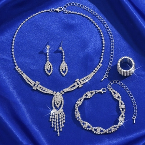 Sparkling silver rhinestone jewelry set with necklace, earrings, bracelet and ring on blue silk