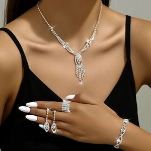 Sparkling silver rhinestone jewelry set featuring fringe necklace and drop earrings on model