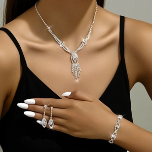 Detailed view of silver crystal bridal jewelry set worn by a model in black attire