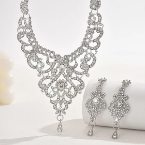 Detailed view of silver bridal jewelry set with sparkling rhinestones and drop pendants
