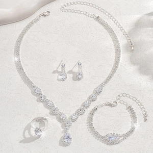 Elegant zircon jewelry set with necklace earrings and bracelet on grey stone