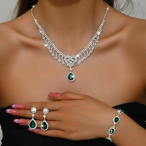 Exquisite silver-tone bridal jewelry set featuring green teardrop crystals and rhinestones