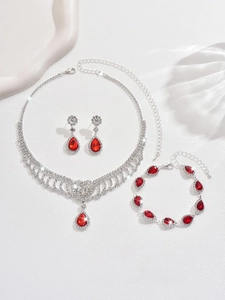 Detail of red teardrop gemstone jewelry set with necklace and earrings on white background