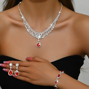 Elegant silver tassel necklace and earring set with red teardrop rhinestones on model