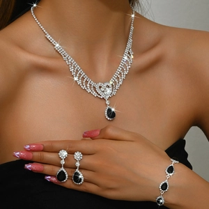 Detail of luxury water drop tassel jewelry set with black teardrop rhinestones on a model