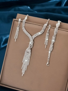 Detailed macro view of bridal rhinestone jewelry set with tassel necklace and earrings