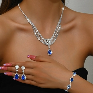 Macro view of crystal teardrop necklace set with vibrant blue stones for gala evening