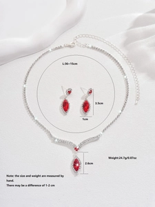 Detailed view of V-shaped bridal jewelry set with red stones and dimensions markup