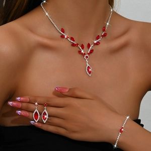 Detail of elegant V-shape bridal jewelry set with red marquise gems and silver rhinestones