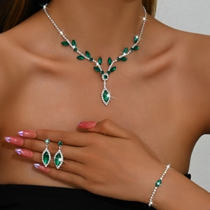Elegant silver necklace set with marquise emerald stones and diamonds on model