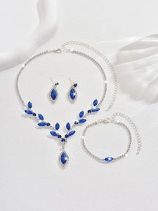 Detail of silver V-shaped jewelry set with blue marquise crystals and rhinestones