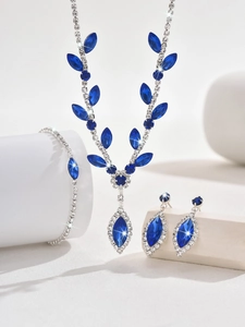 Detail of silver bridal jewelry set with deep blue marquise stones and crystals