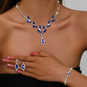 Detail of silver bridal jewelry set with navy blue stones on female model skin