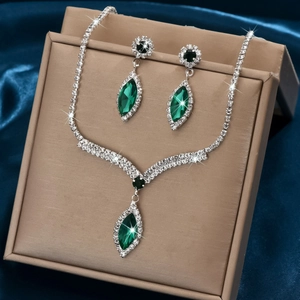 Silver V-shaped bridal jewelry set with emerald marquise stones and white rhinestones