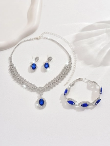 Macro shot of luxury sapphire rhinestone necklace and earring set with silver plating