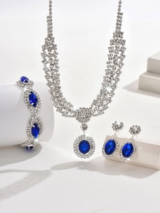 Detailed view of luxury silver jewelry set featuring royal blue sapphire oval pendants