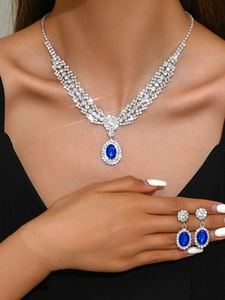 Detail of luxury bridal sapphire blue necklace and earrings set with crystal rhinestones