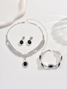 Detailed view of luxury silver-toned jewelry set with oval black stones and sparkling rhinestones