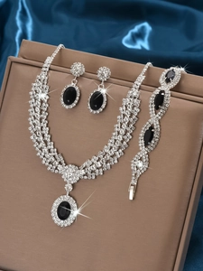 Detail of luxury bridal jewelry set with black gemstones and sparkling rhinestones