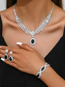 Luxurious jewelry set with black oval gemstones and rhinestones on elegant model