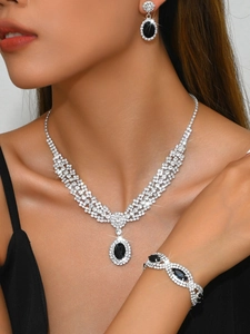 Macro shot of luxury jewelry set with black sapphire oval stones and white rhinestones