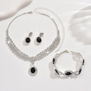 Detailed set of silver jewelry with blue sapphires and crystals on white silk