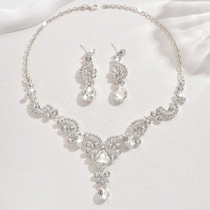 Detailed view of silver bridal jewelry set with sparkling teardrop crystal pendants