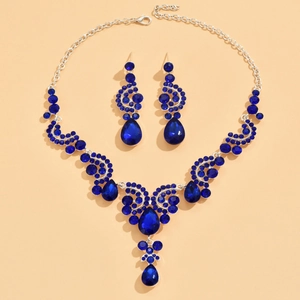 Detail view of silver bridal jewelry set with deep blue waterdrop rhinestones