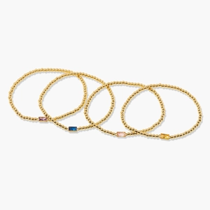 Set of four gold beaded bracelets featuring rectangular gemstones in assorted vibrant colors